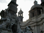 There's a legend that Bernini hated the facade of the church of S. Agnese in the background.  The facade was designed by a former student and rival of Bernini, Borromini. This explains that the statue of the Nile River hides its head to avoid seeing the Borromini facade, and that of the R�o de la Plata raises its arm in alarm to prevent the building from falling. The fountain was, in fact, unveiled in 1651, a year before the church of S. Agnese was begun, two years before Borromini was called in.