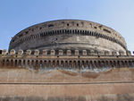 Castel S'Angelo.  Ancient Rome allowed no tombs inside the city walls, so Hadrian built a giant tomb just outside the city along the Tiber.  His mausoleum was a big cylinder topped by a cypress grove and a gold statue of Hadrian himself.  From AD 139 to AD 217 emperors were buried here.  In 590, Pope Gregory converted it to a fortified palace after seeing a vision of archangel Michael sheathing his sword (a plague had just ended).  The Pope made it into a prison and palace.  Cellini, the Florentine goldsmith and sculptor defended it and was imprisoned here.  