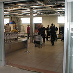 Grandma taking pictures of us while she is still in customs.  