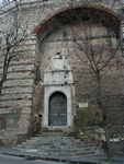 Door in city wall to a street