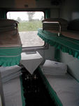 The inside of a "hard sleeper" car.  There are fancier cars called "soft sleepers," complete with fake potted plants and paintings