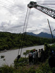 The crane tried, unsuccessfully, to pull a tanker truck from the steep bank.  The truck driver lived but his passengers were killed