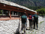 Our first attempt at turning prayer wheels.  We are doing it the wrong way.  Later we learned to spin them clockwise by hitting them with our right hands.  Almost always the ranks of prayer wheels are in the middle of the path, so one can pass on either side.
