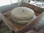 Millstones in a little mill at the base of  the waterfall