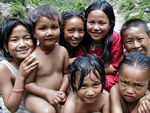 Kids swimming at the base of the waterfall