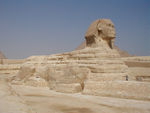 The Sphinx stands just outside Khafra's valley temple.  It was carved in place out of the limestone bedrock.  It's about 60 feet tall.  Between the front paws is the "dream stele," a signpost put up by Tuthmosis IV in the 18th dynasty (1555 - 1305 BC, i.e. about 1000 years after the Sphinx was carved) describing how the king was hunting nearby when he dreamt of an oracle that promised him the crown of Egypt if he ordered the sand that had accumulated around the statue removed.  