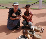 Monica with a cobra wrapped around her next.  Another one is popping out of the basket in front of her.