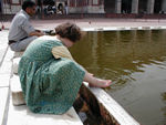 Washing feet in the courtyard's pool